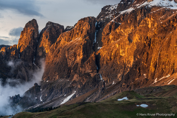 Last light on the mountain wall with a waterfall