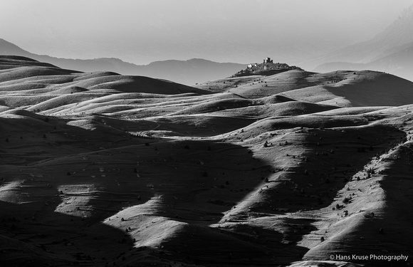 Rolling hills on Campo Imperatore with the old castle.